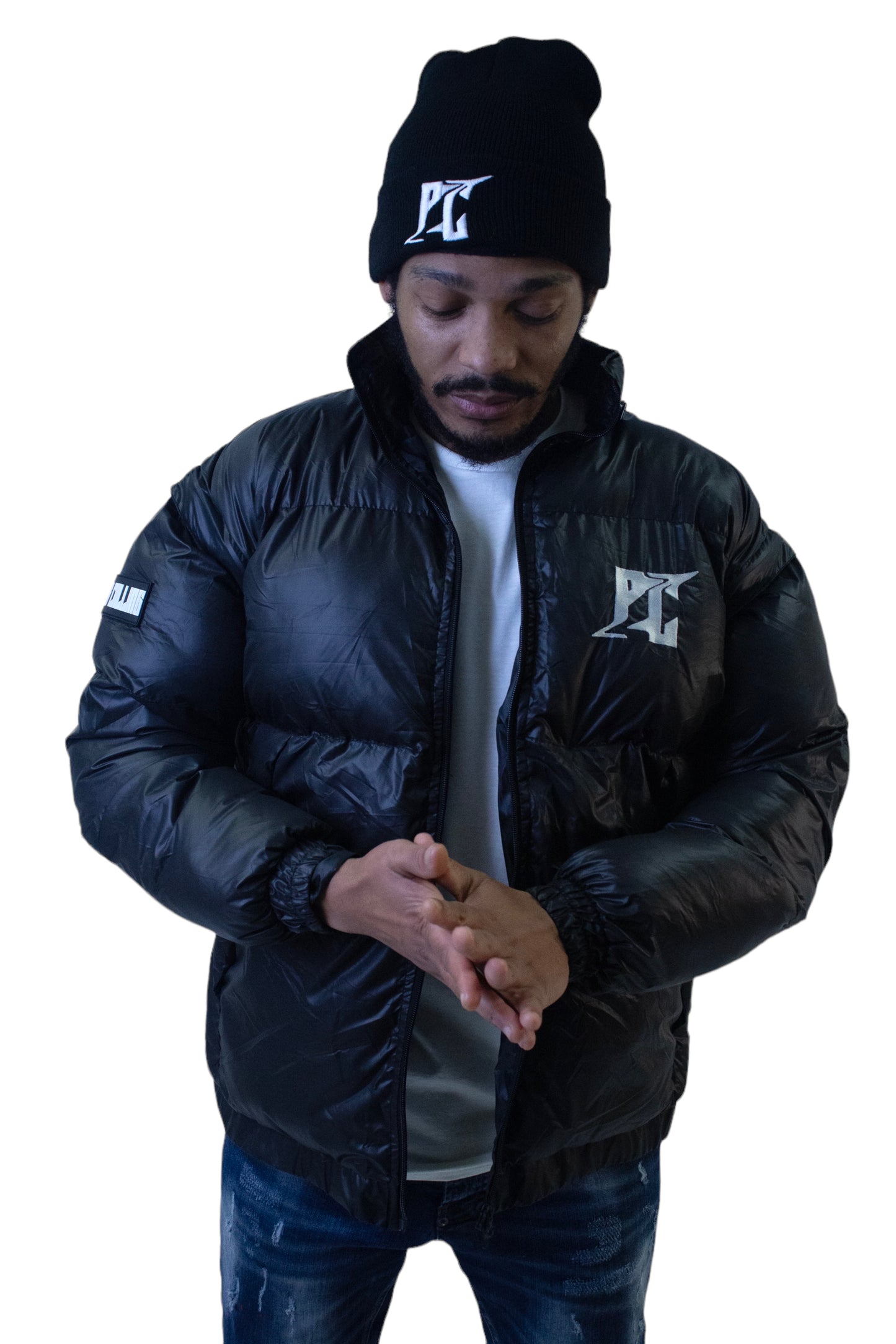 Man wearing black PC Convertible Jacket and matching beanie, showcasing stylish and empowering streetwear from an inspirational clothing brand.