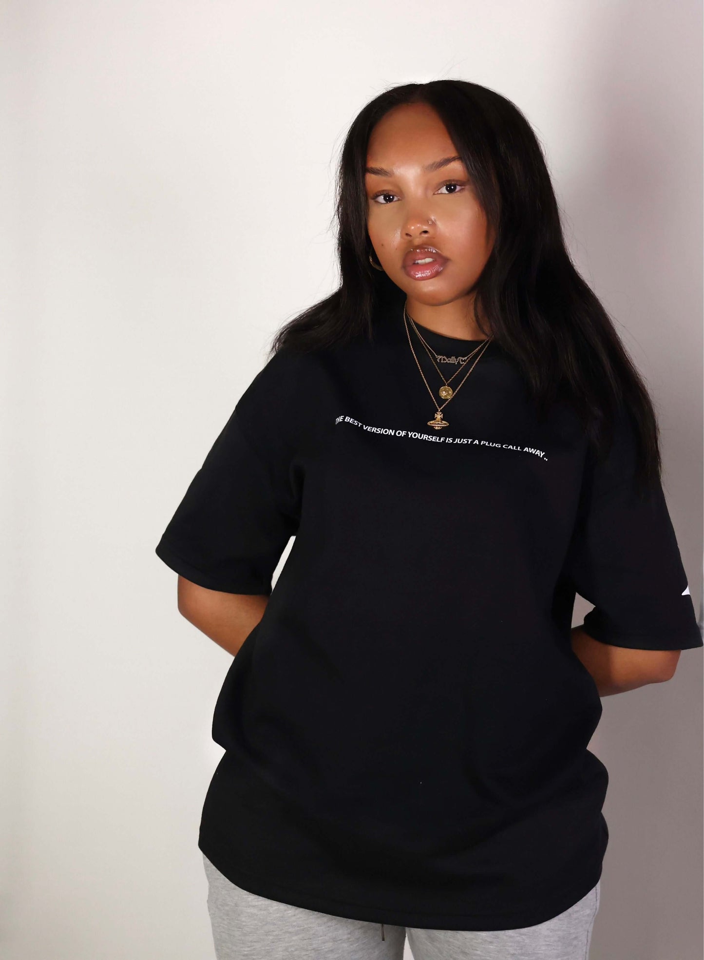 Unisex boxy drop sleeve tee with DTG inspirational quote print, worn by a model, black color from an empowering clothing brand.